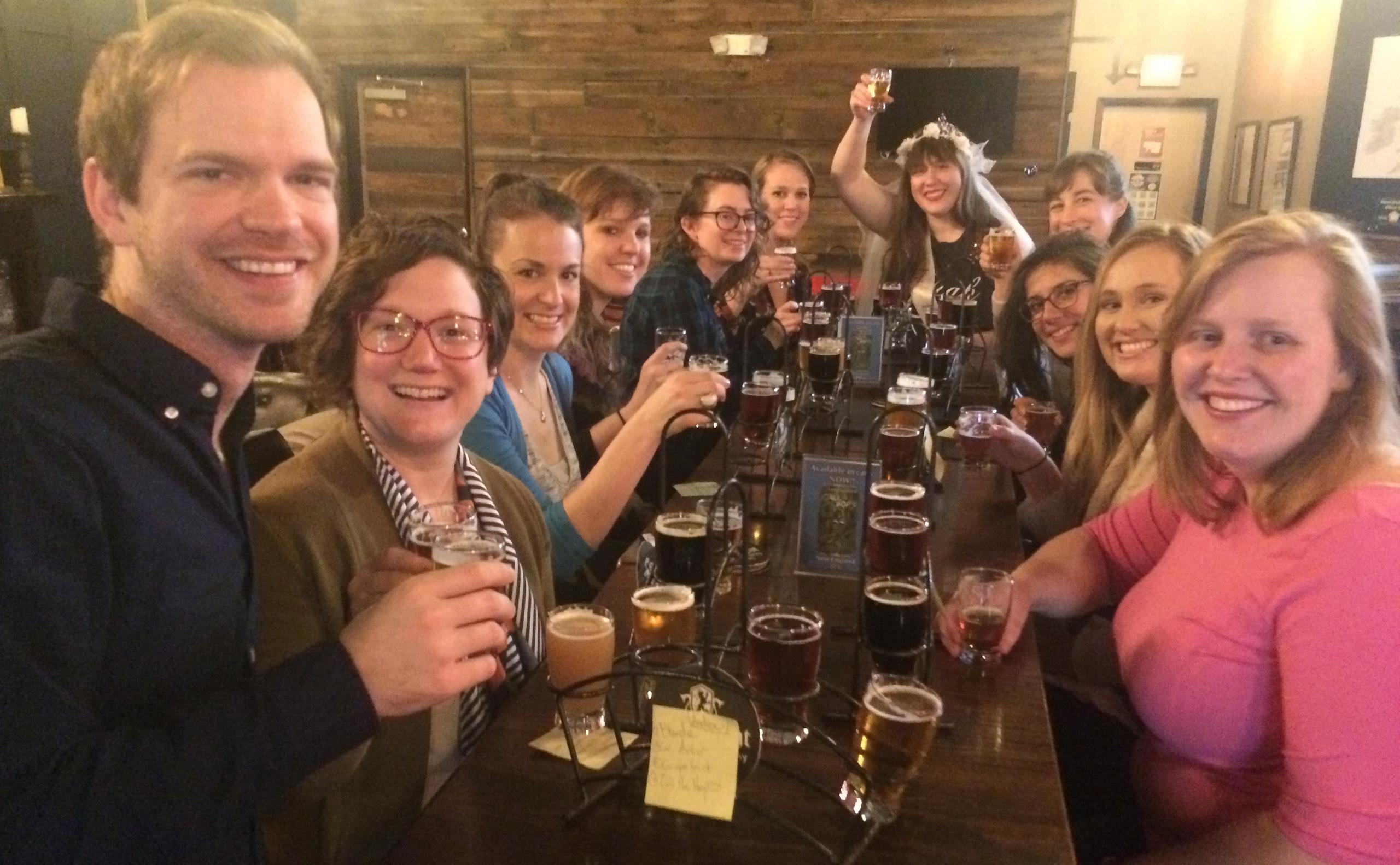 a group of people holding wine glasses and smiling at the camera